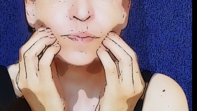 woman massages her cheek Self-facial massage: a woman massages her cheek.