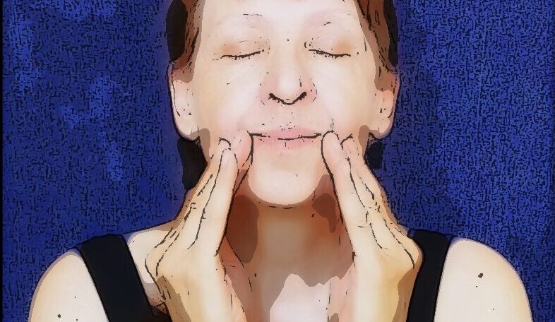 woman massages the corners of her mouth Self facial-massage: a woman massages the corners of her mouth.